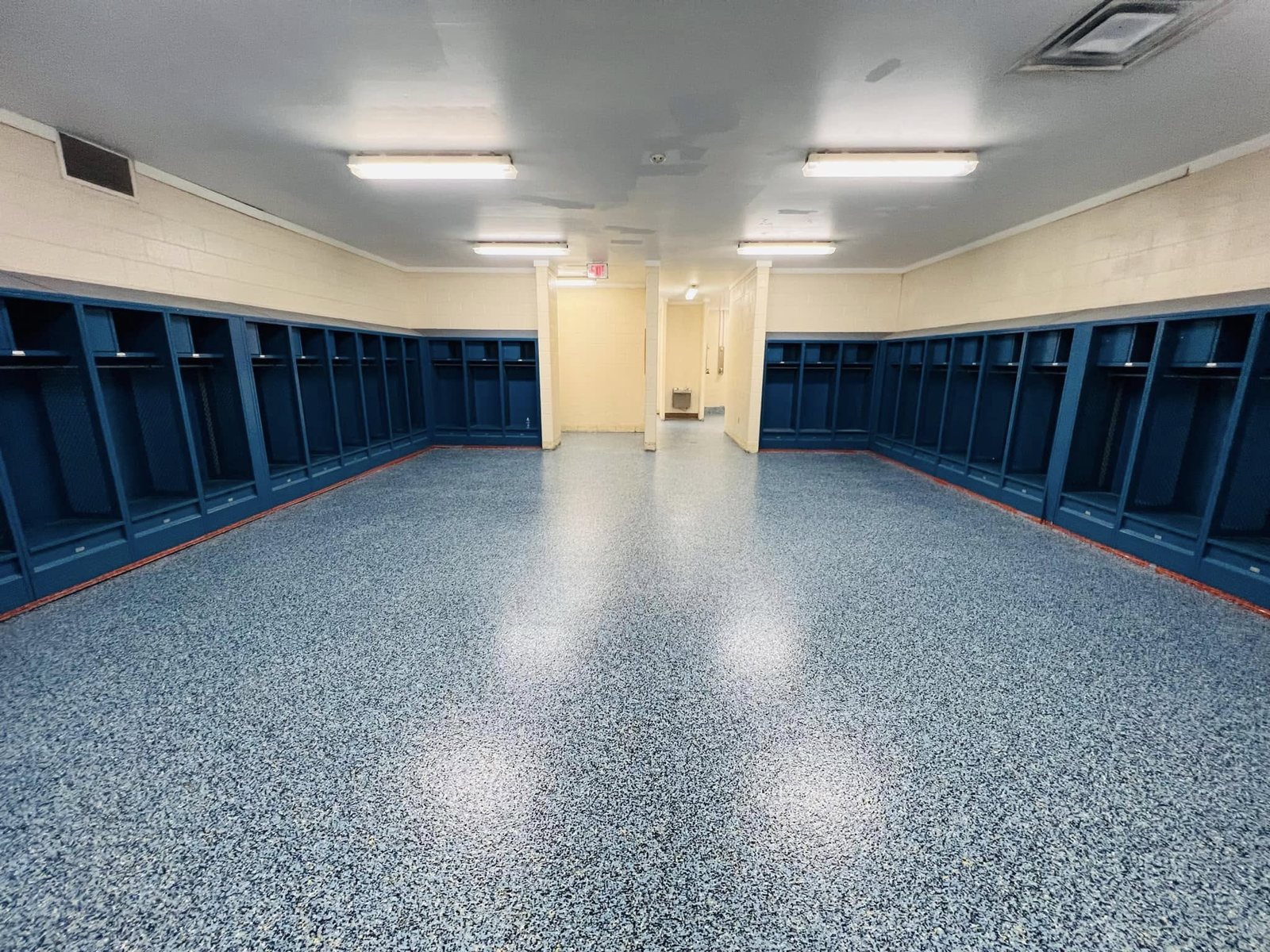 Beige interior locker room with an epoxy-coated floor