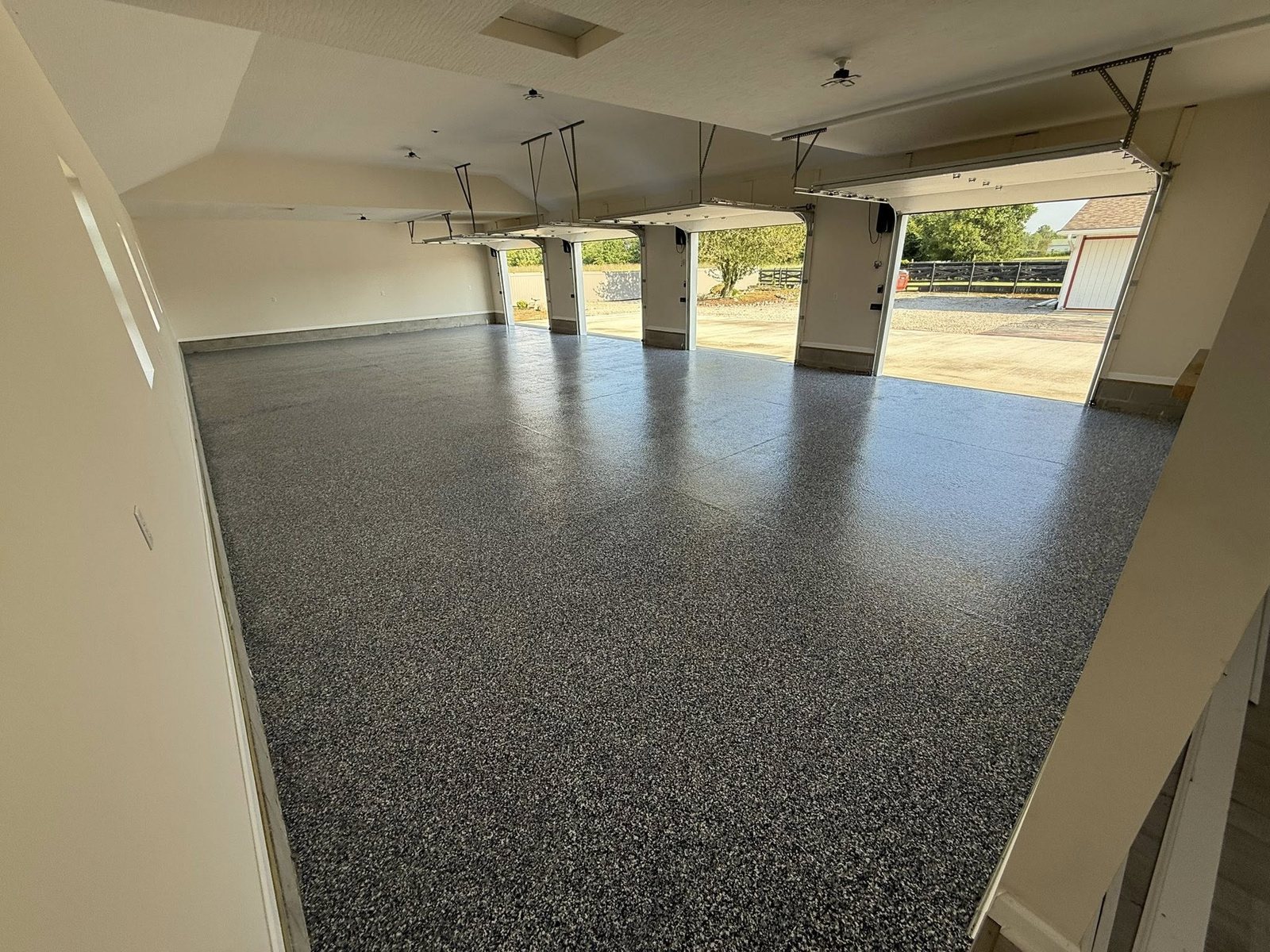 Tan flake epoxy coating on a clean, finished garage floor